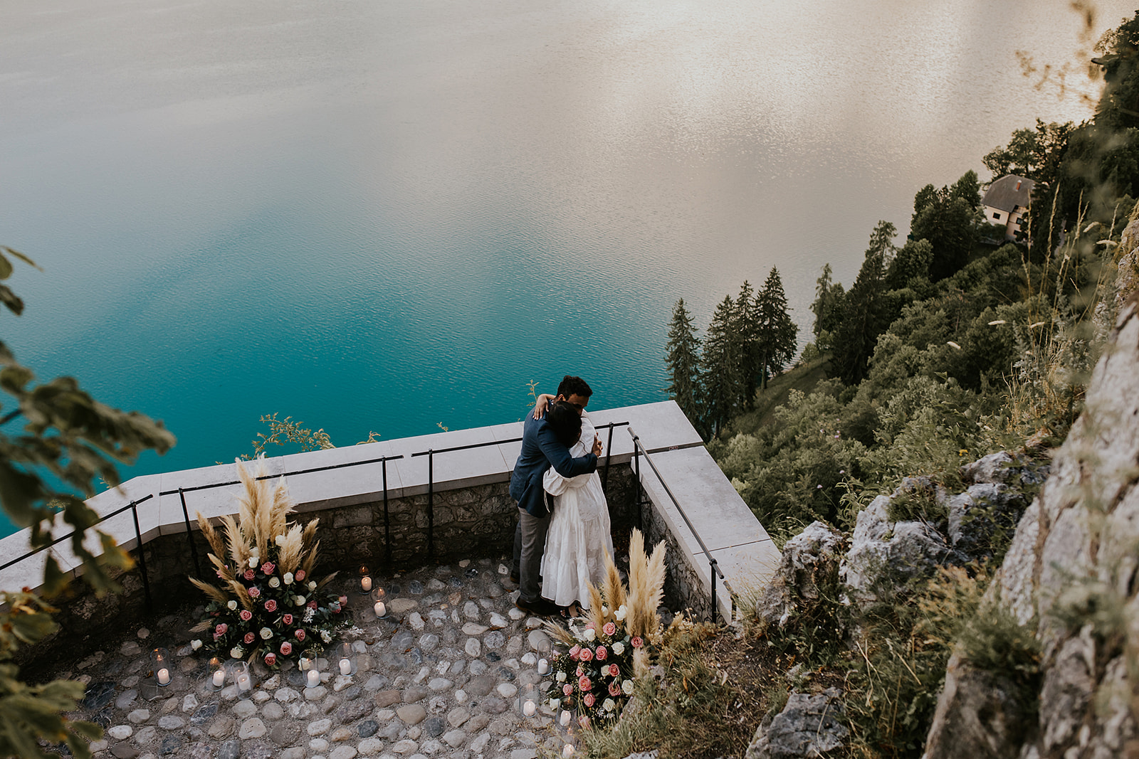 Couple embracing at their Lake Bled proposal, captured by the photographer