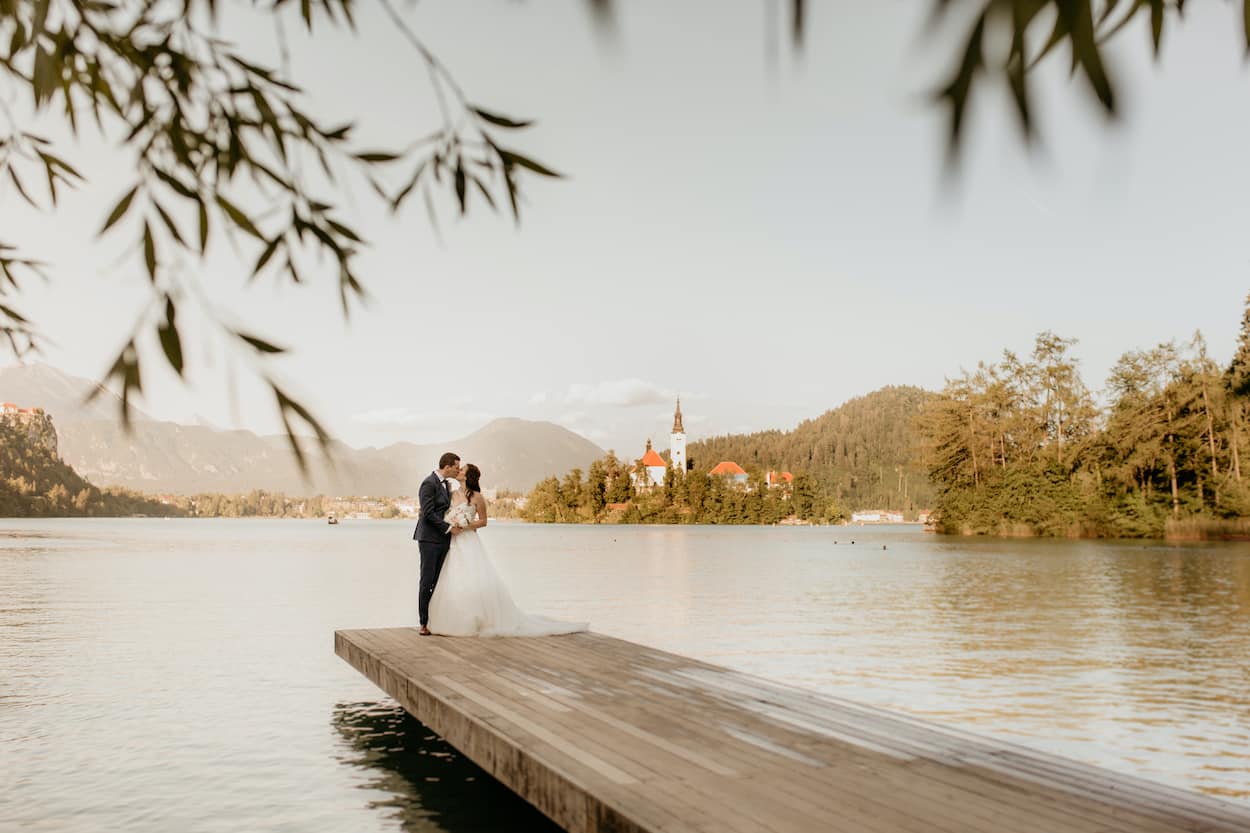 Elopement couple standing in front of Lake Bled