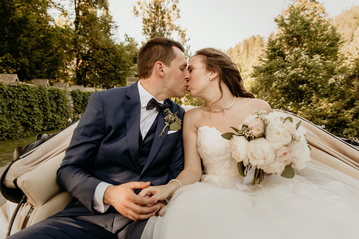 Lake Bled wedding portfolio photo of bride and groom kissing in the carriage