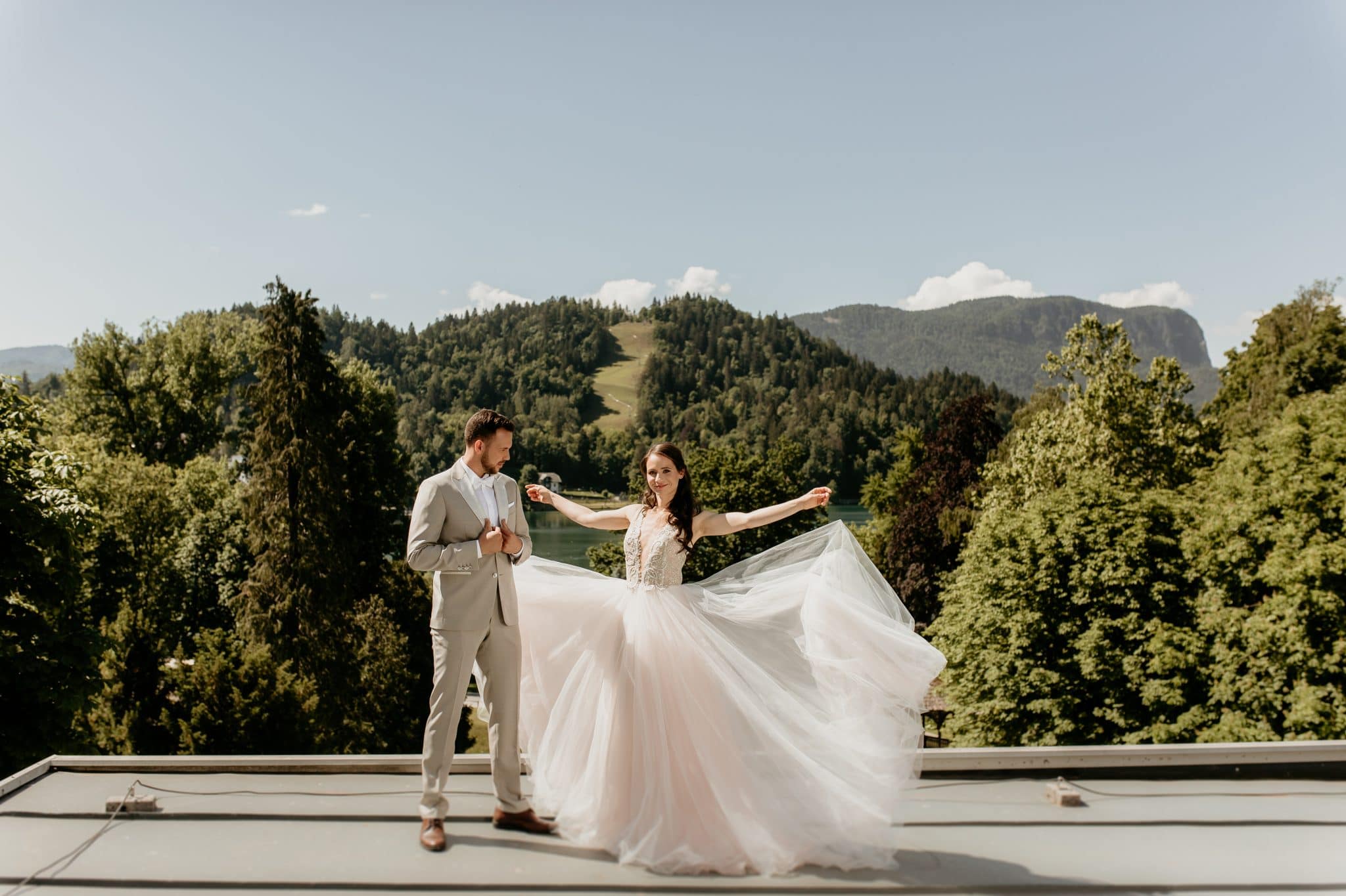 Lake Bled groom and bride with her hands spread
